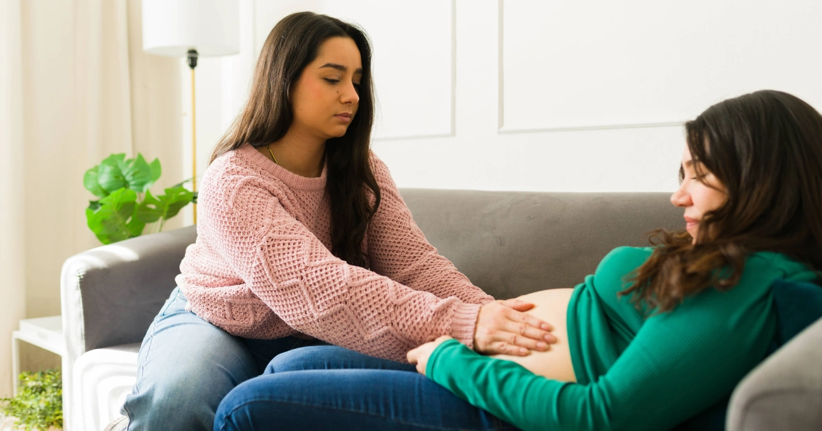 A partner giving a pregnant woman a prenatal massage in Hollywood, FL